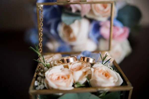 a wedding gold rings in a transparent box