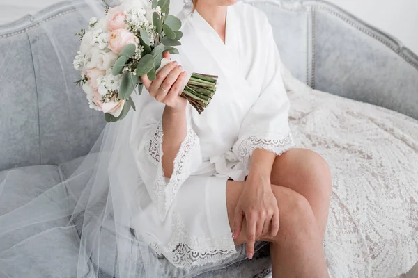 朝に白いローブを着た花嫁が花束を手に — ストック写真