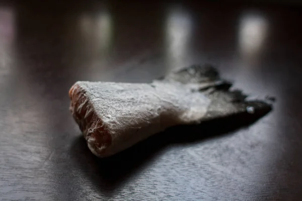 Frozen salmon tail on dark kitchen table — Stock Image Frozen Salmon Tail Dark Kitchen Table Stock Image