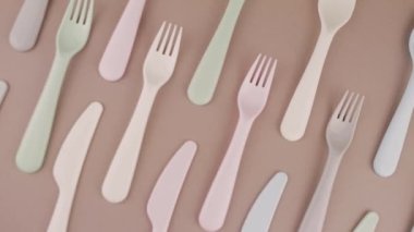 Farklı renklerde yeniden kullanılabilir plastik çatal bıçak seti mutfak masasında çatal bıçak.