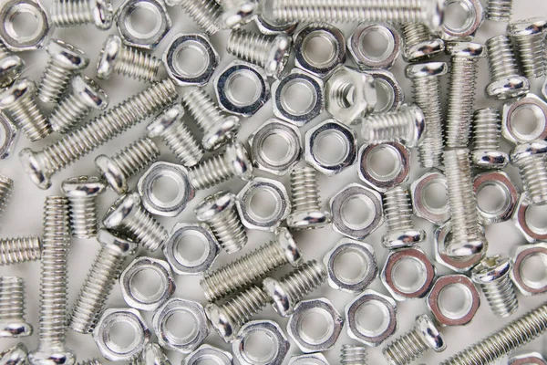a iron screws and nuts on a white background for repair close up