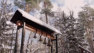 church bells in a snowy forest in winter