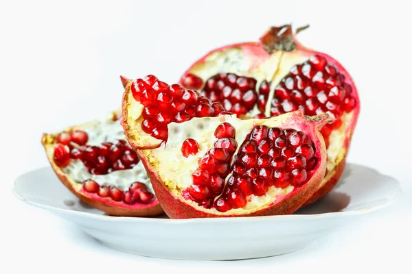 Ripe juicy pomegranate fruit on white background — Stock Photo, Image