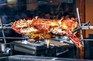 Tükürüğün üzerinde iştah açıcı ızgara kuzu. Geleneksel barbeküde kavrulmuş domuz. Kavurma barbekü bir koç, kuzu veya koyun hazırlanır. Sokak yemekleri, yakın çekim.