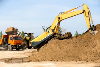 Yellow backhoe working digging