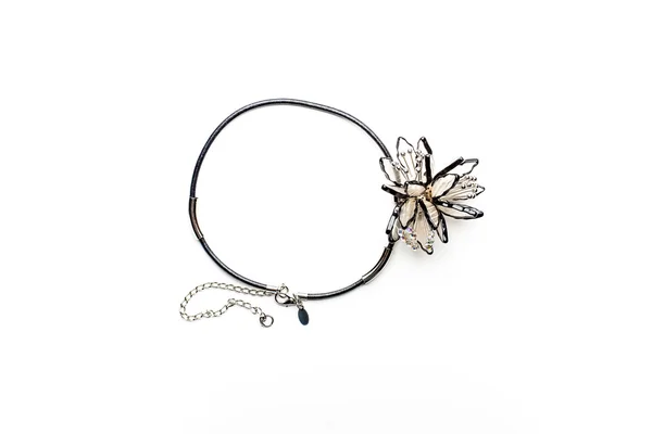 Necklace on black cord and a decorative flower — Stock Photo, Image