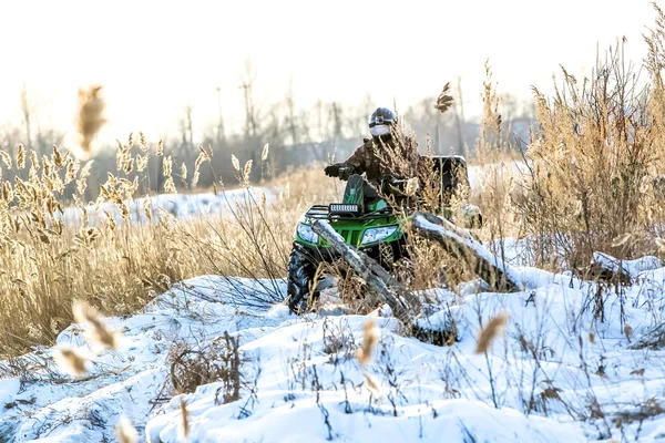 Quad bike on a winter in field — Stock Photo, Image