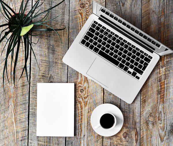 Working place at home with laptop on wooden table