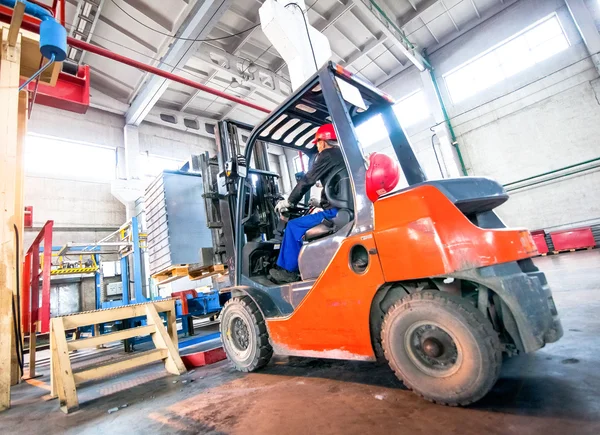 Auto loader with concrete blocks in the warehouse factory — Stock Photo, Image