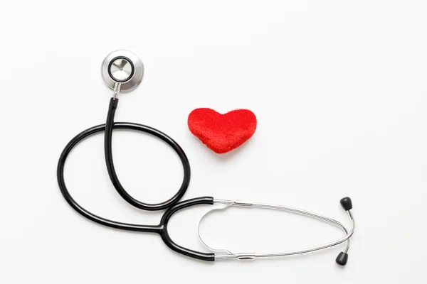 Stethoscope on white background with plush heart — Stock Photo, Image