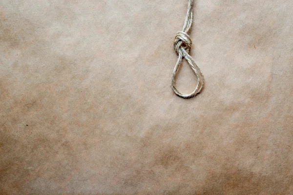 Concept hangmans knot on kraft paper background — Stock Photo, Image