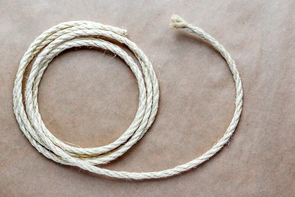 rope coiled at kraft paper on the background