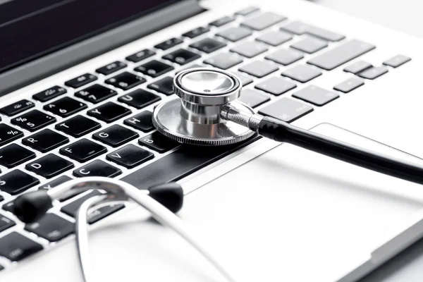 doctor workplace with a stethoscope and laptop