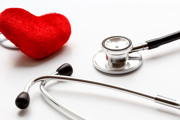 Stethoscope on white background with plush heart — Stock Photo, Image