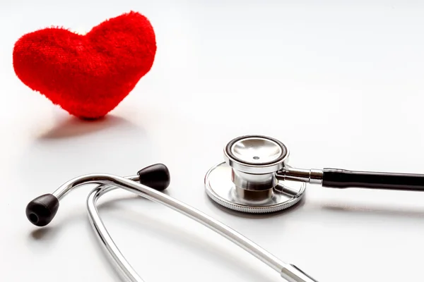 Stethoscope on white background with plush heart — Stock Photo, Image