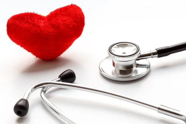 Stethoscope on white background with plush heart — Stock Photo, Image