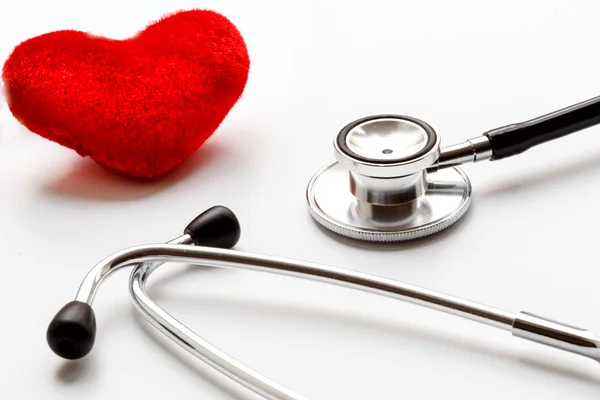 Stethoscope on white background with plush heart — Stock Photo, Image