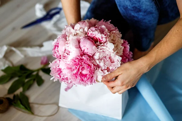 Bloemist maken een bouguet van pioenrozen — Stockfoto