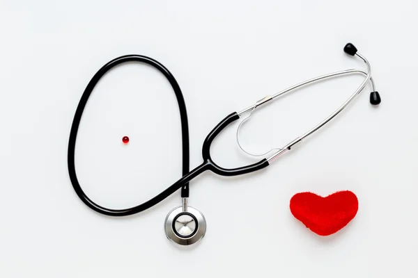 Stethoscope on white background with plush heart top view — Stock Photo, Image