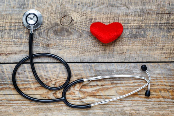 New stethoscope with plush heart on wooden table top view — Stock Photo, Image