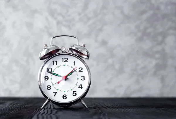 Alarm clock at empty locker on white background close up — Stock Photo, Image