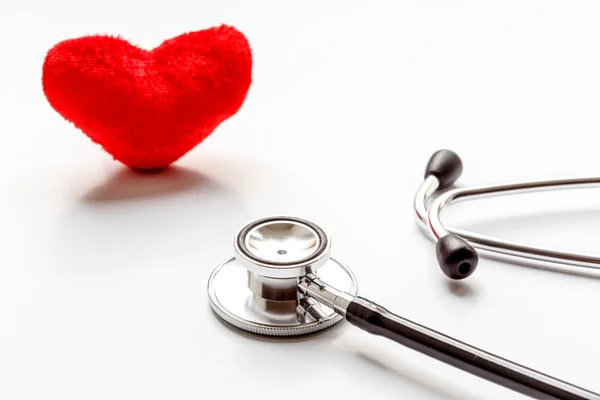 Stethoscope on white background with plush heart — Stock Photo, Image