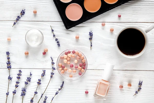 makeup set on white table with lavender top view