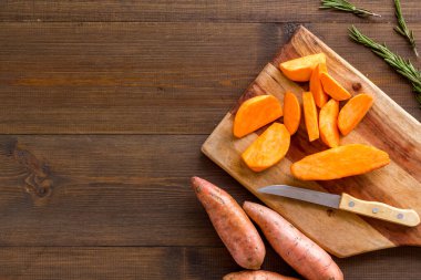 Tatlı patates - dilimlenmiş tatlı patates organik sebzeler kesim tahtasında, yukarıdan manzara