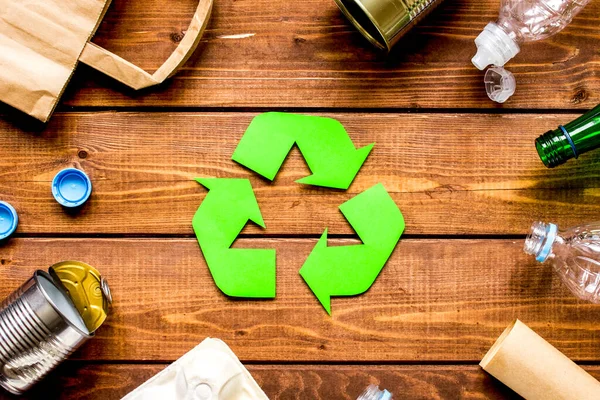 environment concept with recycling symbol on wooden background top view