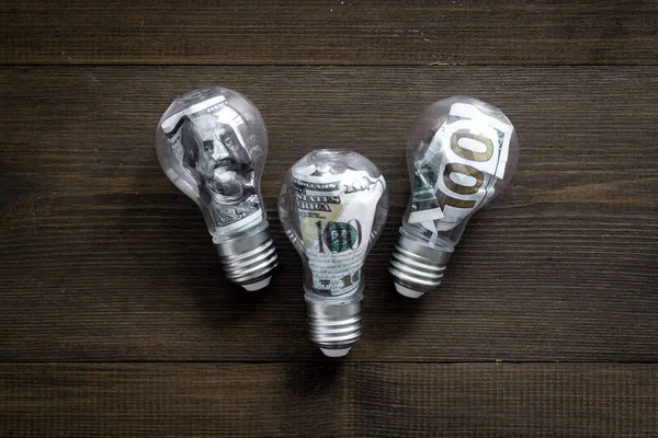 Save money and energy power concept - dollar in light bulb