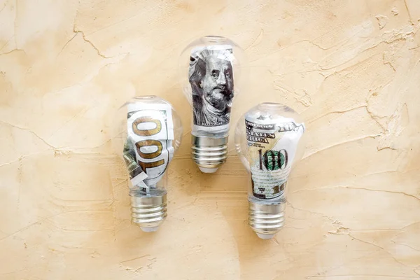 Money in light bulb - renewable eco energy concept