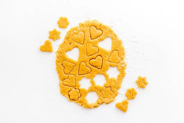 Heart shaped cookies cutting on dough, top view — Stock Photo, Image