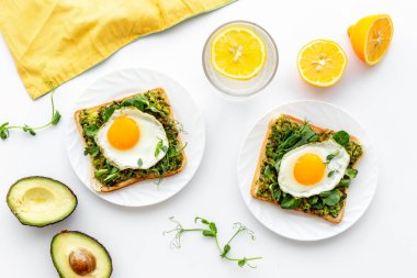 Avokado tostları ve kızarmış yumurtalarla kahvaltı.