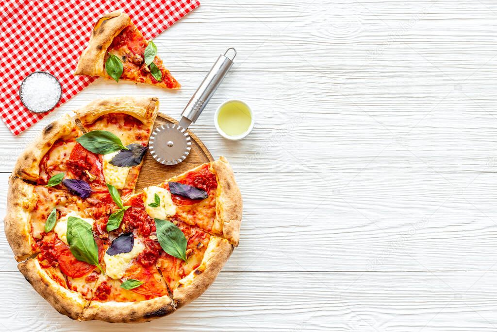 Pizza slices with tomatoes cheese and basil, top view