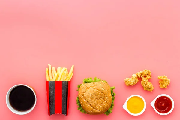 Layout of junk food - french fries burger and chicken nuggets