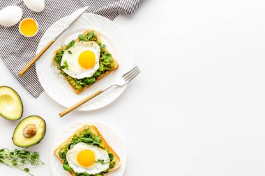 Yumurta ve avokado, kızarmış ekmeğin üzerinde ıspanak. Üst görünüm