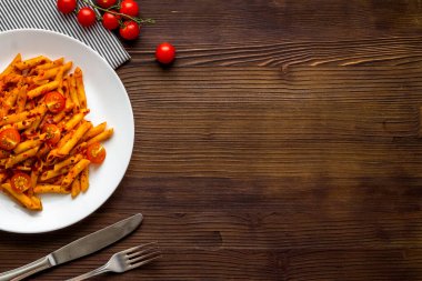 Bir tabak makarna, domates sosu ve otlu makarna.