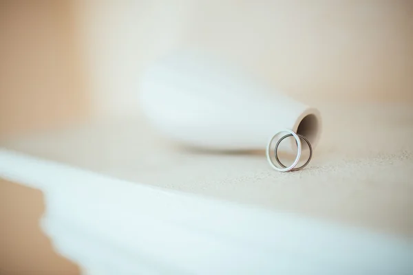 Wedding rings on the pure white table