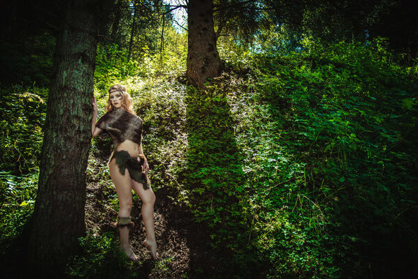 Wild nice girl with a loincloth in nature