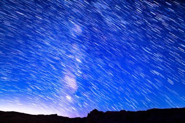 Star Trails of Milky Way Galaxy Night to Sunrise in West Sky at 24mm Above Red Rock Canyon Astrophotography Night Sky in California USA