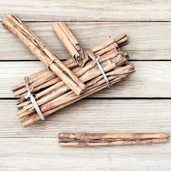 top view of cinnamon sticks on a wooden background