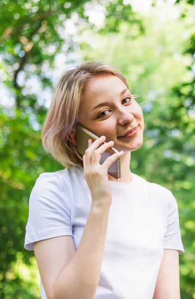 girl is talking on the phone, writing SMS and surfing the Internet.