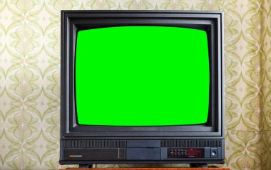 Antika ahşap bir dolapta yeşil ekranlı antika televizyon, 1980 ve 1990 'ların tarzında bir evde eski tasarım..