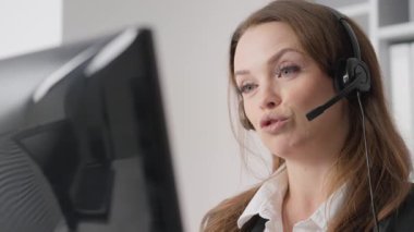 Becerikli bir müşteri destek aracısı, müşterileri tatmin etmek ve soruşturmayı etkili bir şekilde çözmek için bir ofiste, kulaklık kullanarak, istisnai iletişim ve profesyonellik sergileyerek, müşterilerle etkileşim kurar.