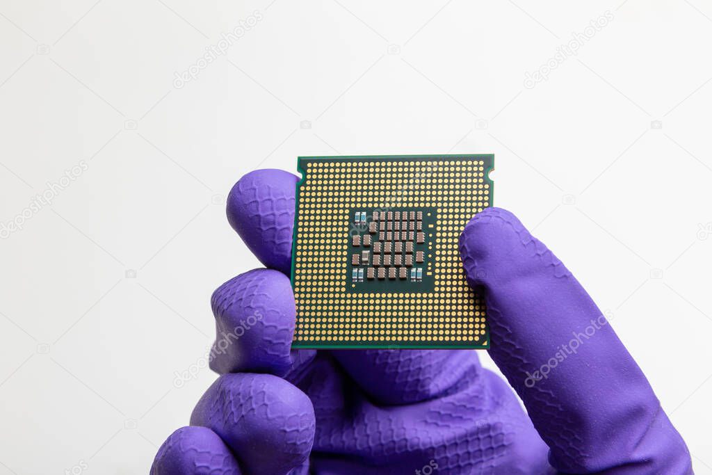 production of central processing units, gloved hand holds a cpu
