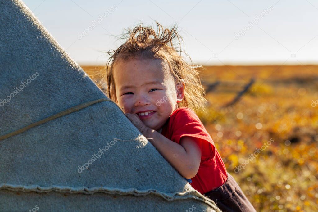 The extreme north, Yamal, life of Nenets people, the dwelling of the peoples of the north, a girl playing in a yurt in the tundra