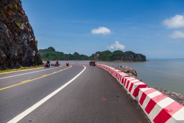 Cat Ba Island, Vietnam, 2019-06-19:Cat Ba Island, girl and man biker riding a scooter in the mountains of Vietnam, tourists travelers riding a motorcycle scooter in Vietnam clipart