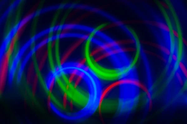 abstract background, colored circles on a black background, circles in motion