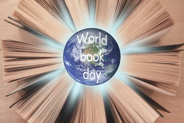 World book day, world literature concept. Planet Earth on books background. Elements of this image were furnished by NASA.