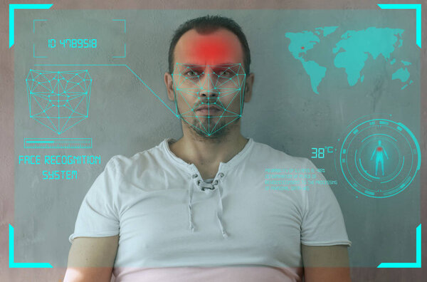 Facial recognition system, concept. Young man on the gray background, face recognition, individual human biometrics according to world standards, the ID passport